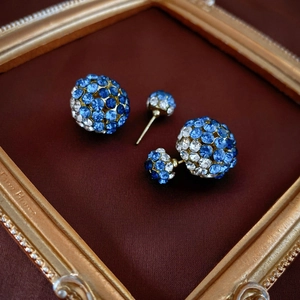 Vintage gold double-sided stud earrings with blue and white pavé crystals in spherical design