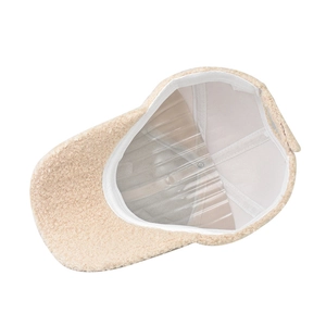 Detailed interior of a beige faux shearling baseball cap showing sweatband and texture