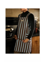 Detail of blue and brown striped cotton apron with large side pockets and H-back straps