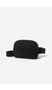 Detail view of high-quality black nylon material and minimalist texture of the waist bag