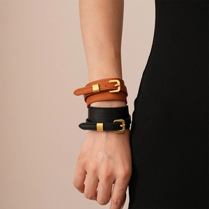 Double-wrap faux leather belt buckle bracelet in black and brown with gold hardware