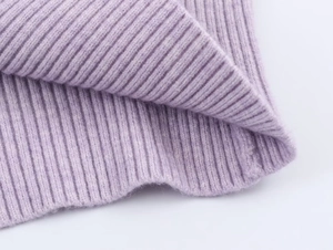 Macro close-up of lavender purple ribbed knit fabric texture with vertical stripe details
