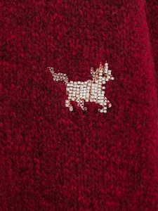 Detailed view of red mohair knit texture featuring intricate horse bead embroidery