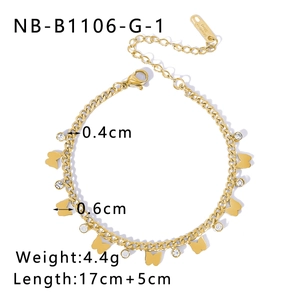 Detail of gold butterfly cuban link bracelet with clear zircon charms on white background