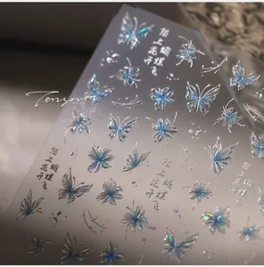 Detailed view of holographic butterfly nail stickers with artistic chrome finish
