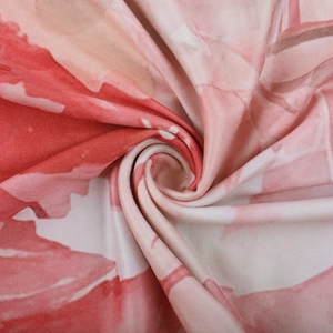 Detailed macro view of red and pink floral lace fabric with soft elastic knit texture