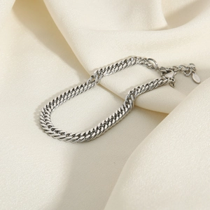 6mm thick stainless steel Cuban link bracelet for men and women on beige silk background