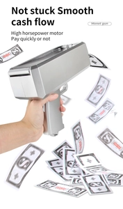 Close-up of silver electric money gun shooting prop notes with high-speed motor