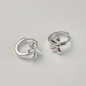 Close-up of 925 sterling silver bow hoop earrings with polished metallic finish