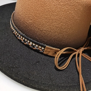 Detail of felt fedora hat featuring rhinestone chain and brown braided band trim