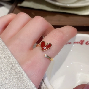 Macro shot of 18k gold plated open ring with red enamel heart and white zircon stone