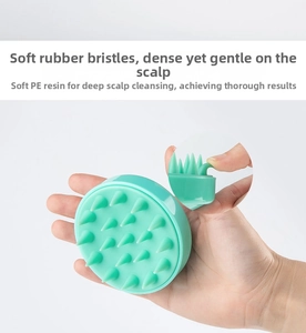 Flexible mint green silicone bristles on a hair scalp massager for deep scalp cleaning