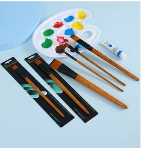 Artistic set of 6 nylon paint brushes with wood handles on creative light blue background