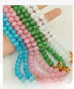 Close-up of multicolored cat eye stone beaded necklaces with gold lobster clasps