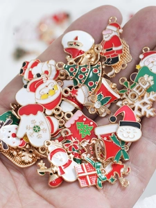 Detailed close-up of mixed Christmas enamel charms including Santa and Xmas trees