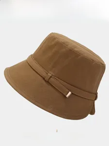 Detail of brown cotton bucket hat featuring fine herringbone texture and golden buckle