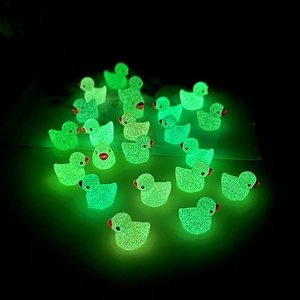 Fluorescent green mini resin ducks glowing in the dark for DIY micro landscape decor
