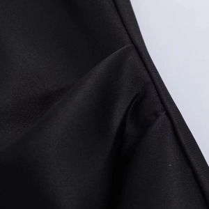Detail of black twill satin fabric showing high-quality stitching and smooth texture