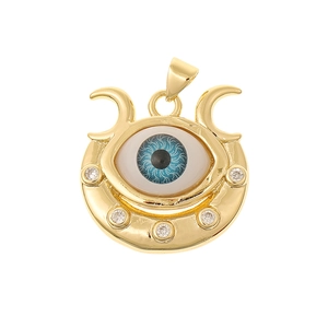 Macro shot of gold Evil Eye pendant with blue eye center and sparkling zircon accents