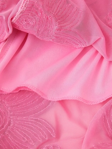 Close-up of pink lace fabric with floral embroidery and smooth lining texture