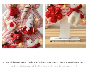 Detail of pink knitted Christmas tree with felt ornaments, LED lights and wooden base