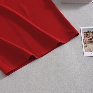 Detail of red knit dress showing high-quality cotton texture and seamless stitching