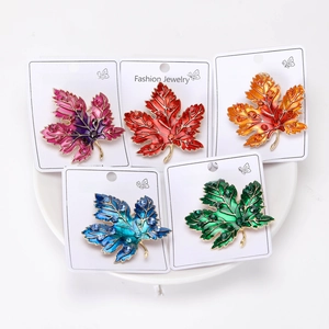 Detailed set of five maple leaf brooches with vibrant enamel and sparkling rhinestones