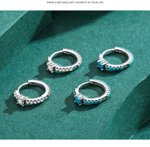 Detailed macro shot of S925 silver hoop earrings with turquoise and white zircon accents
