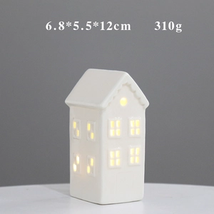 Detail of white ceramic house with warm LED light, size 6.8x5.5x12cm, 310g weight