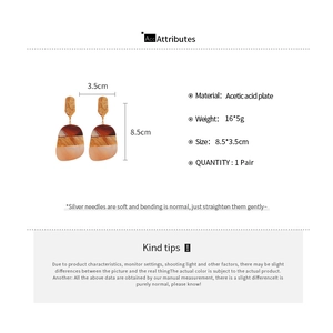 Detailed spec view of acetate oval drop earrings with brown marble texture dimensions
