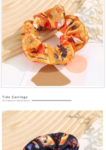 Detail of Halloween satin hair scrunchies with pumpkin and bat prints on orange and black