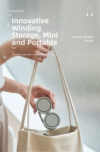 Portable neck fan with innovative winding storage fitting into a beige handbag