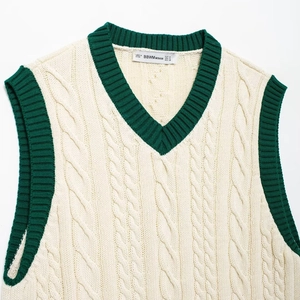 Women's V-neck cable knit vest in cream with green contrast ribbed edges