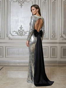 Silver sequin backless evening gown with a large black bow and long sleeves