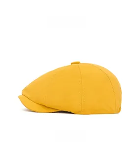 Side view of a bright yellow cotton newsboy cap with top button and six-panel stitching