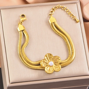 Double-layer gold snake chain bracelet with pearl flower pendant in a jewelry box