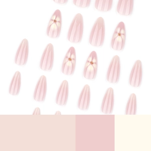 Minimalist almond press-on nails with white flowers and golden beads in soft nude pink