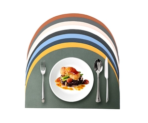 Detailed top view of arched PU leather placemats in multiple colors with tableware