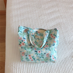 Detailed top view of a vintage floral cotton handbag with blue flower patterns