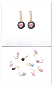 Detail of heart drop earrings with gold base, colorful enamel, and inlaid zircon stones