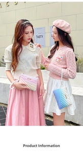 Close-up of pink and blue gradient clutch bags with V-shaped quilting and gold logos