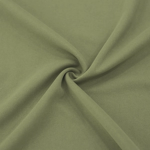Macro shot of olive green knitted fabric texture and soft drape of the men's trench coat