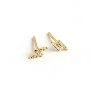 Sparkling gold lightning bolt stud earrings with cubic zirconia on white background
