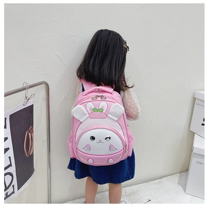 Pink cartoon bunny preschool backpack with 3D ears and sequins shown on a child model