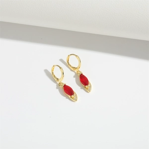 Close-up of red marquise-cut gemstone earrings with sparkling accents in gold plating