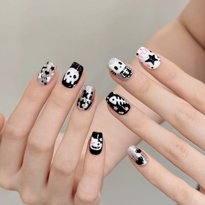 Punk style press-on nails featuring black and white hand-drawn kitty graffiti and silver glitter