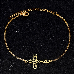 Detail shot of golden stainless steel cross bracelet with engraved Grace lettering
