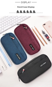 Detailed scene of three large capacity Oxford cloth pencil cases in blue, red, and black