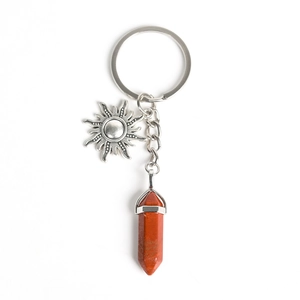 Natural crystal keychain featuring sun charm and reddish-brown hexagonal stone pillar