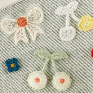 Embroidered cherry and bow patches in vibrant colors for DIY clothing and hair accessories